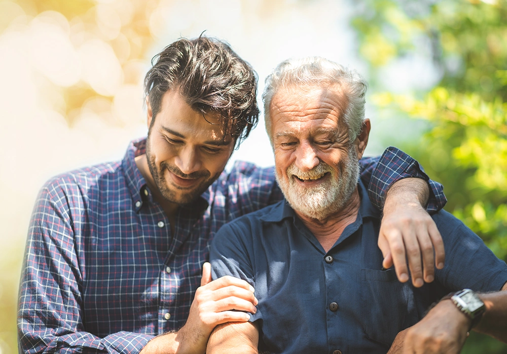 senior father with adult son walking outdoors